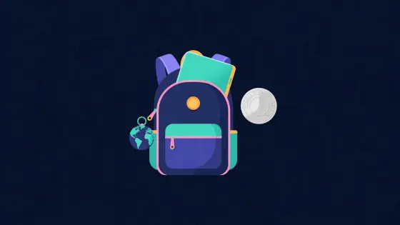 Backpack with laptop and globe keychain beside a coin shaped stamp