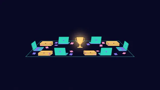Laptops around a table with pizza boxes, sticky notes and a trophy