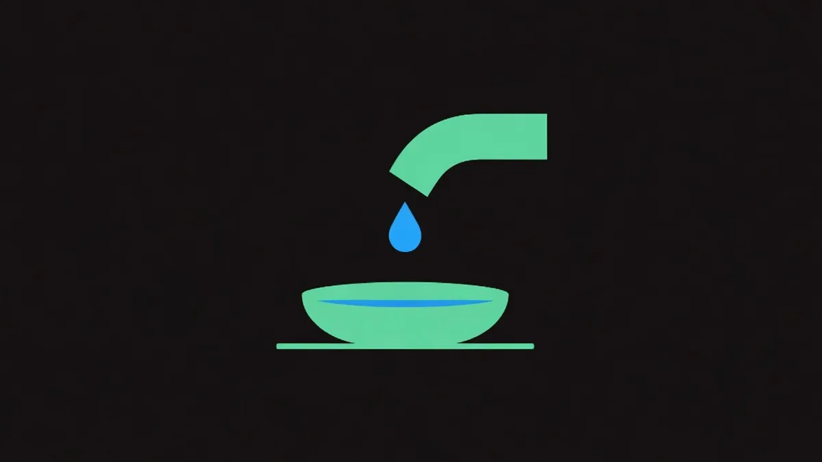A small drip falling into a shallow dish