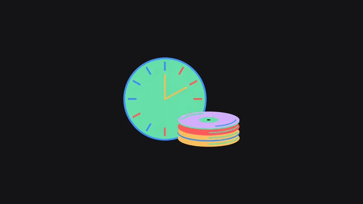 A clock face beside a stack of records